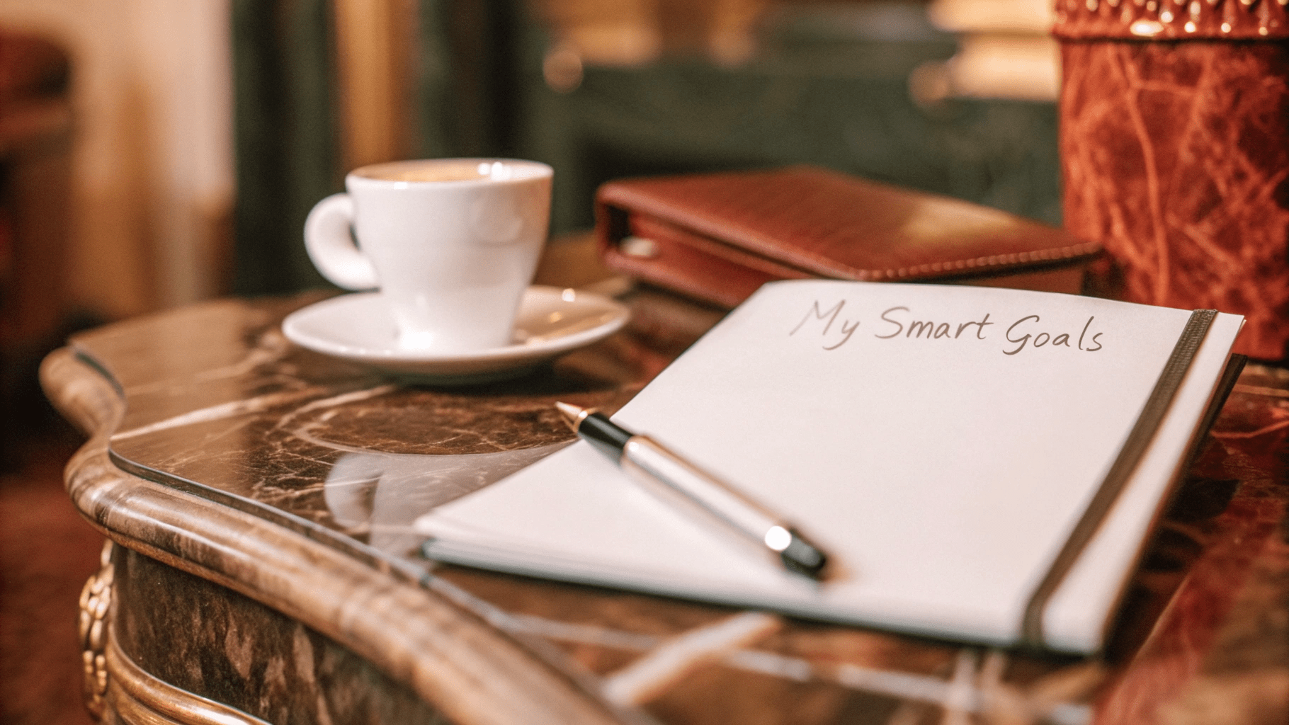 Smart-Goals-On Table A Note On A Table Next To A Cup Of Coffee And A Notepad Ready To Set Smart Goals